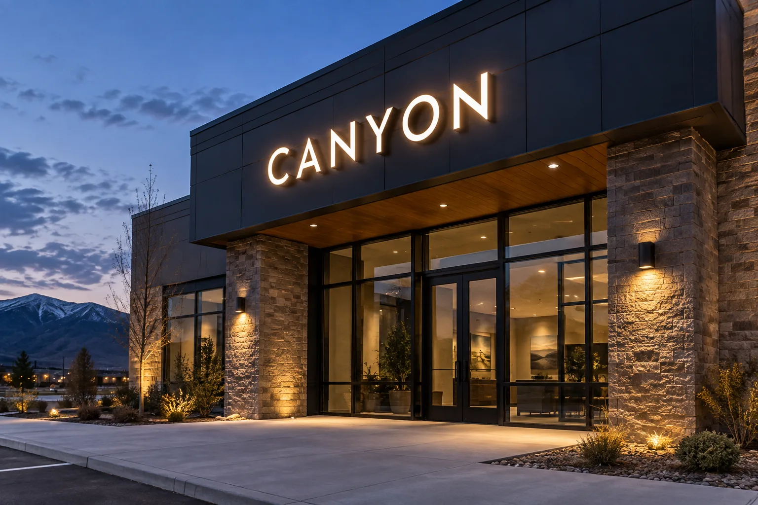 Evening concept visualization of illuminated CANYON letters on a fictional commercial building